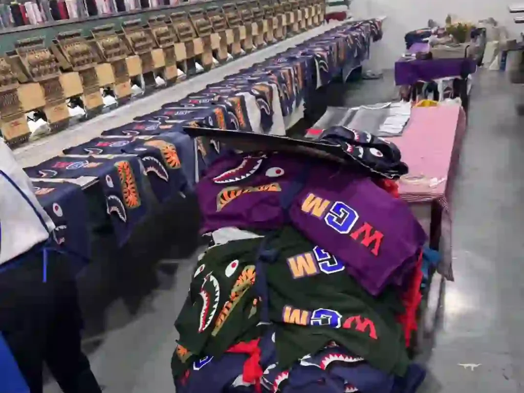 BAPE shark hoodies production line with embroidered WGM logos in a clothing factory