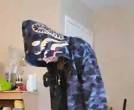 Young American man in a blue camo shark hoodie, casual streetwear look
