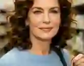 Young American woman smiling, wearing light blue top, testimonial avatar